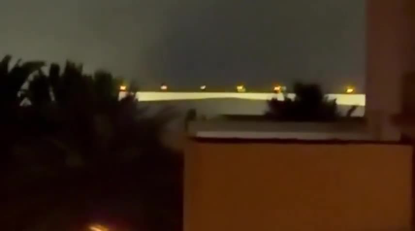 Iran's IRGC is launching a large-scale ballistic missile and drone attack on Kuwait and Bahrain in response to today's U.S. strikes on Iran. Reports indicate direct impacts on the U.S. Navy's 5th Fleet HQ in Bahrain, with footage showing plumes of smoke rising from the area